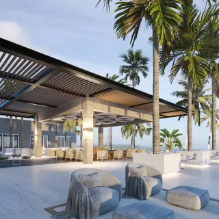 Breeze outdoor terrace at Hyatt Ziva Cancun with modern seating and palm trees overlooking the ocean