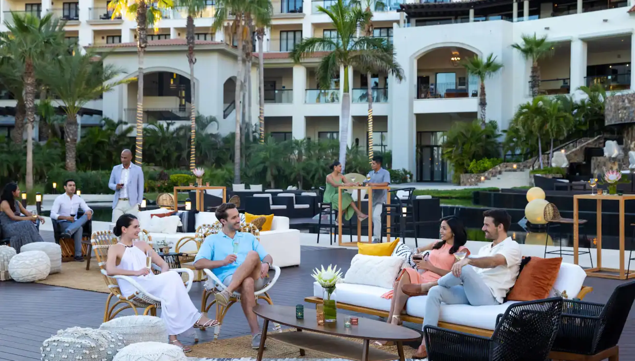 Outdoor lounge area at Hyatt Ziva Los Cabos with guests relaxing on sofas and chairs at sunset, Cabo San Lucas
