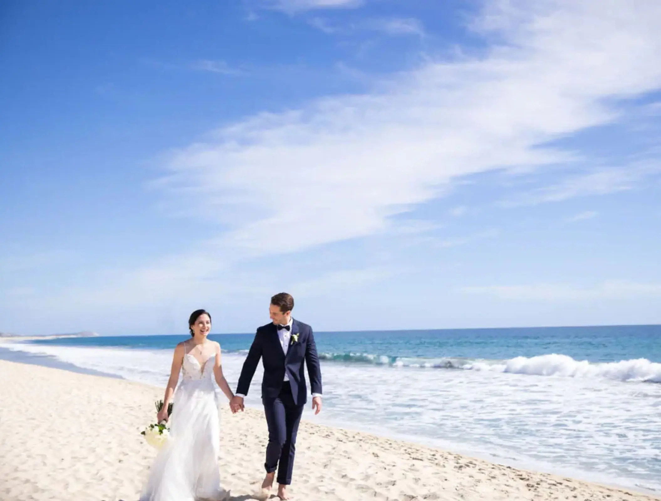 The couple walking along the shoreline at Hyatt Ziva Los Cabos, Cabo San Lucas