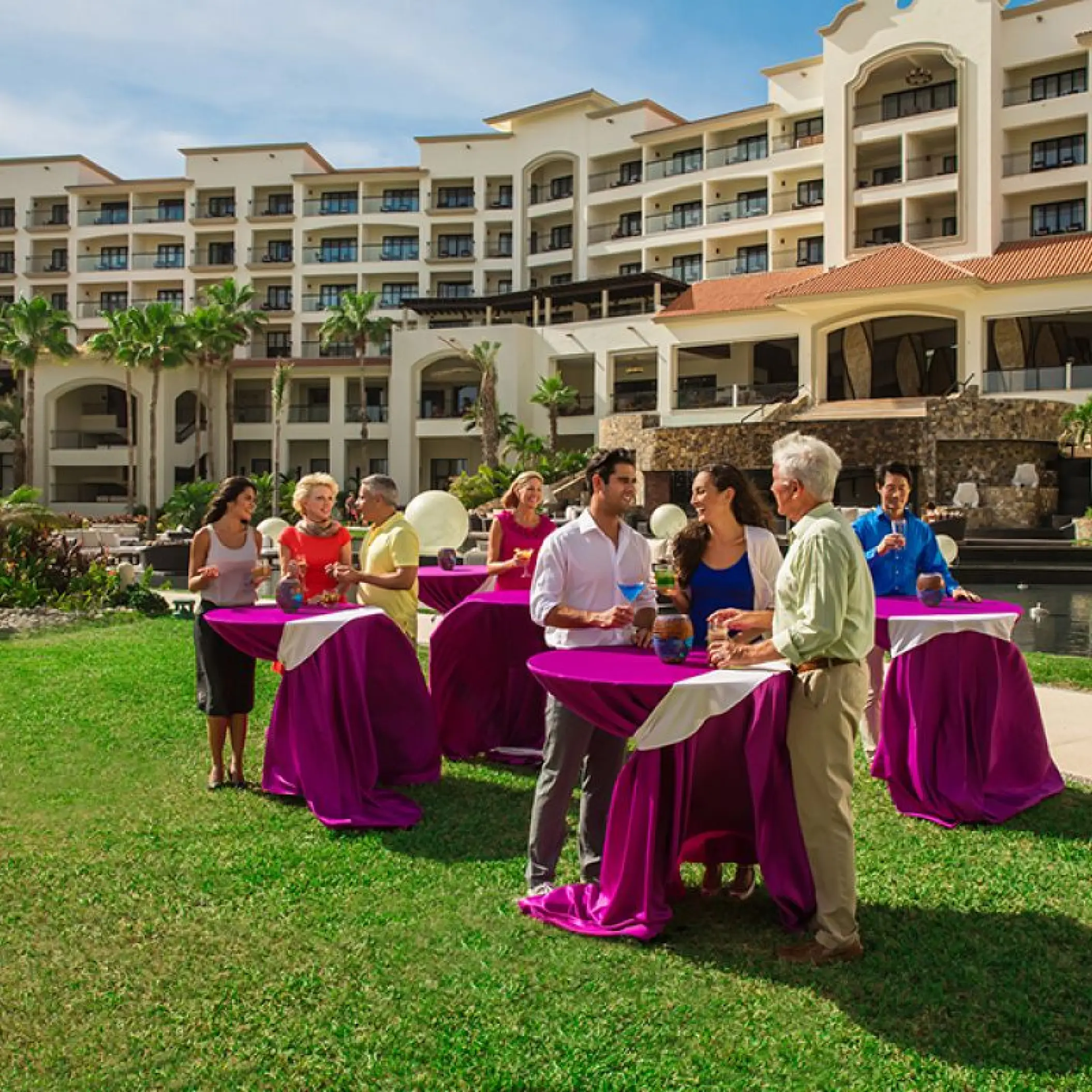 Outdoor cocktail reception on the lawn with purple linens at Hyatt Ziva Los Cabos, Cabo San Lucas