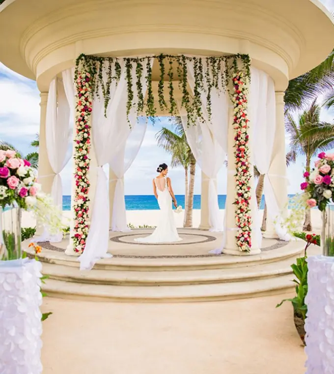 Bride in a white gown standing in the oceanfront gazebo at Hyatt Ziva Los Cabos, Cabo San Lucas