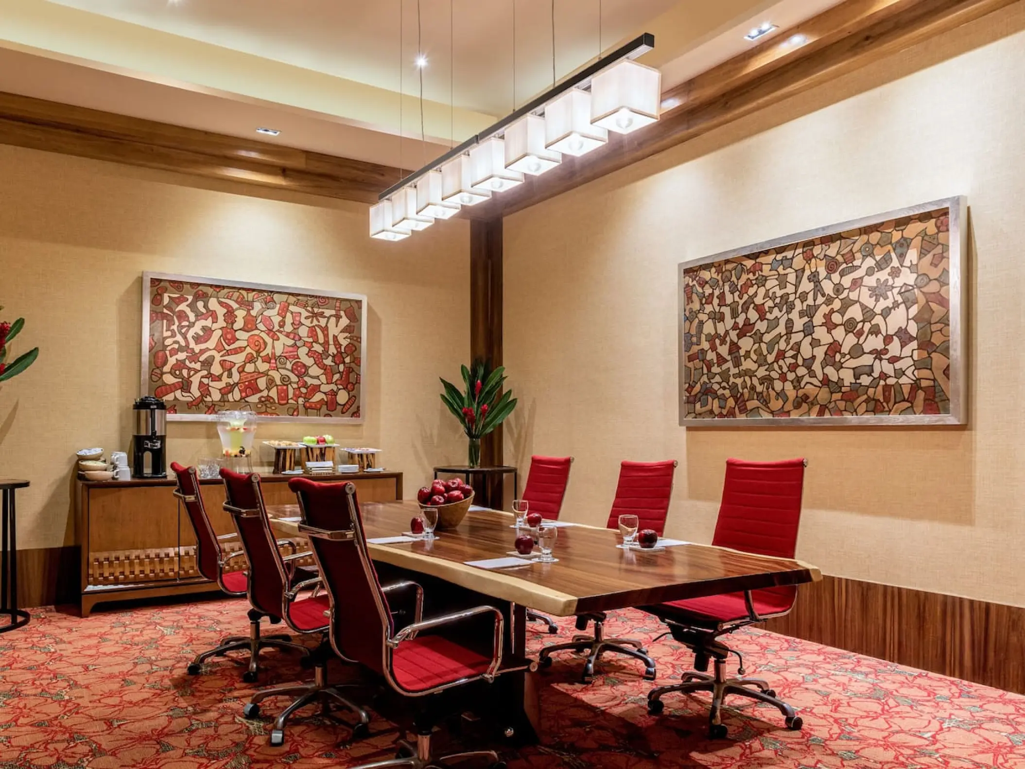 Meeting room with a wooden table and red chairs at Hyatt Ziva Puerto Vallarta