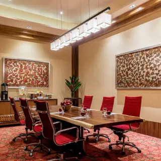 Meeting room with a wooden table and red chairs at Hyatt Ziva Puerto Vallarta