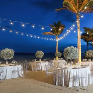 Outdoor wedding reception under string lights on the beach at Hyatt Ziva Los Cabos, Cabo San Lucas