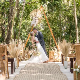 Boho-chic wedding ceremony with pampas grass and triangular arch at Iberostar Selection Cancun