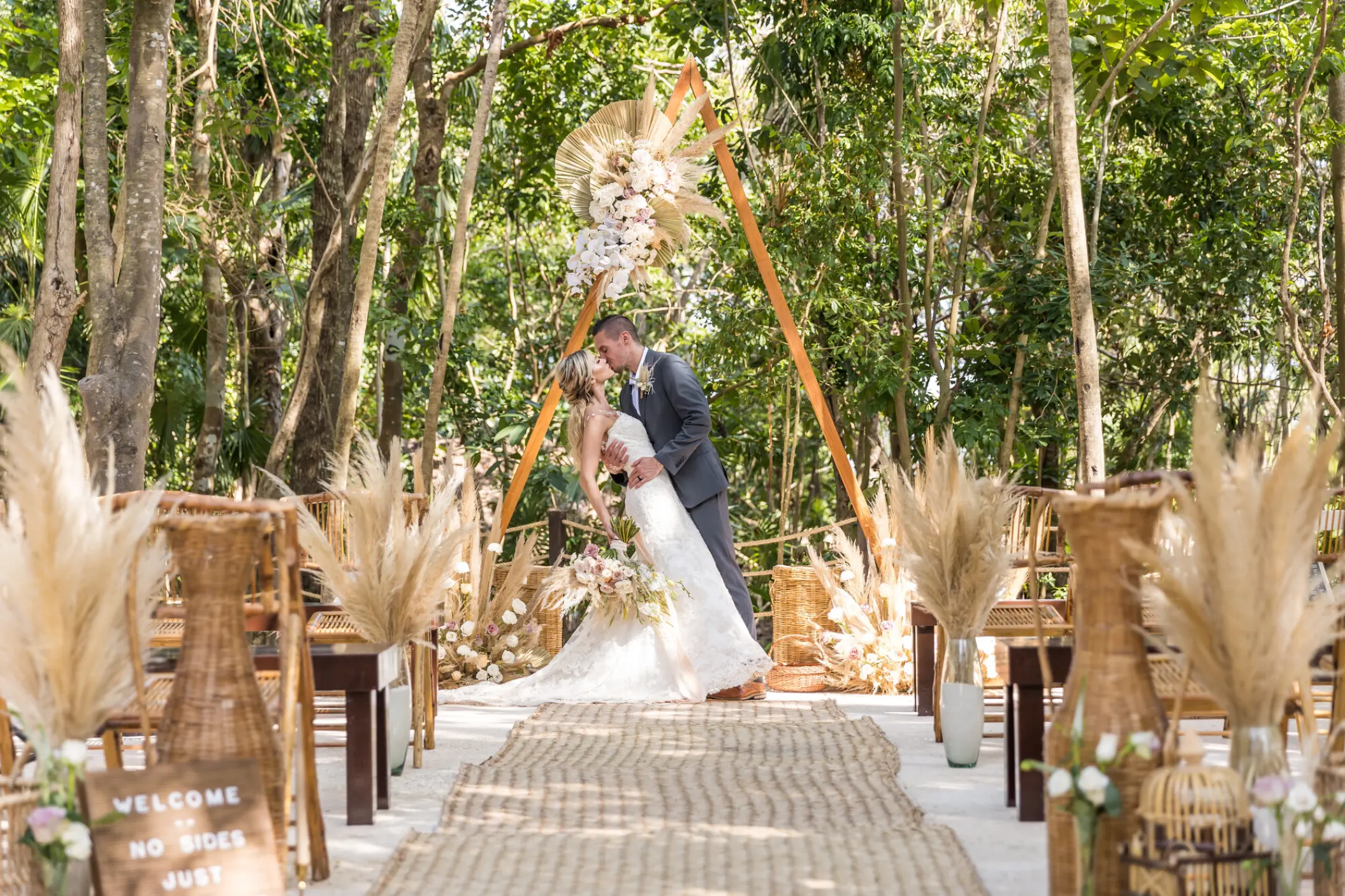 Boho-chic wedding ceremony with pampas grass and triangular arch at Iberostar Selection Cancun