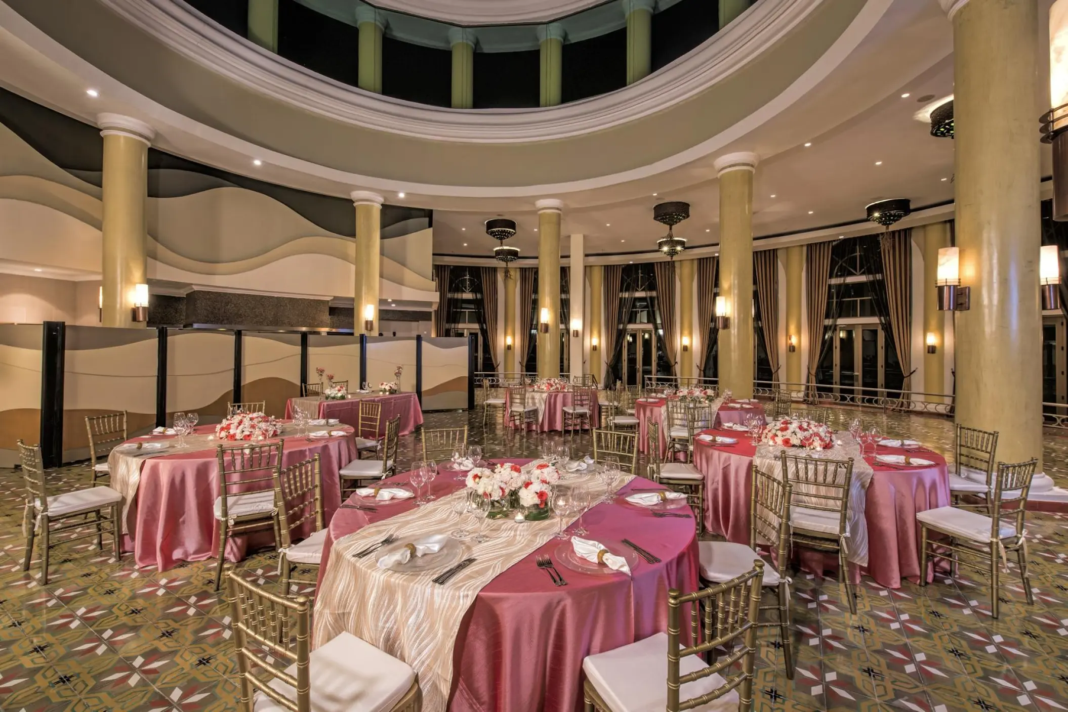 Indoor wedding reception with pink linens and floral centerpieces at JOIA Paraiso by Iberostar, Riviera Maya
