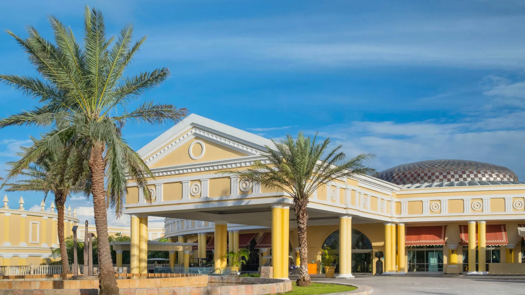 Classical yellow facade and main entrance of JOIA Paraiso by Iberostar, Riviera Maya