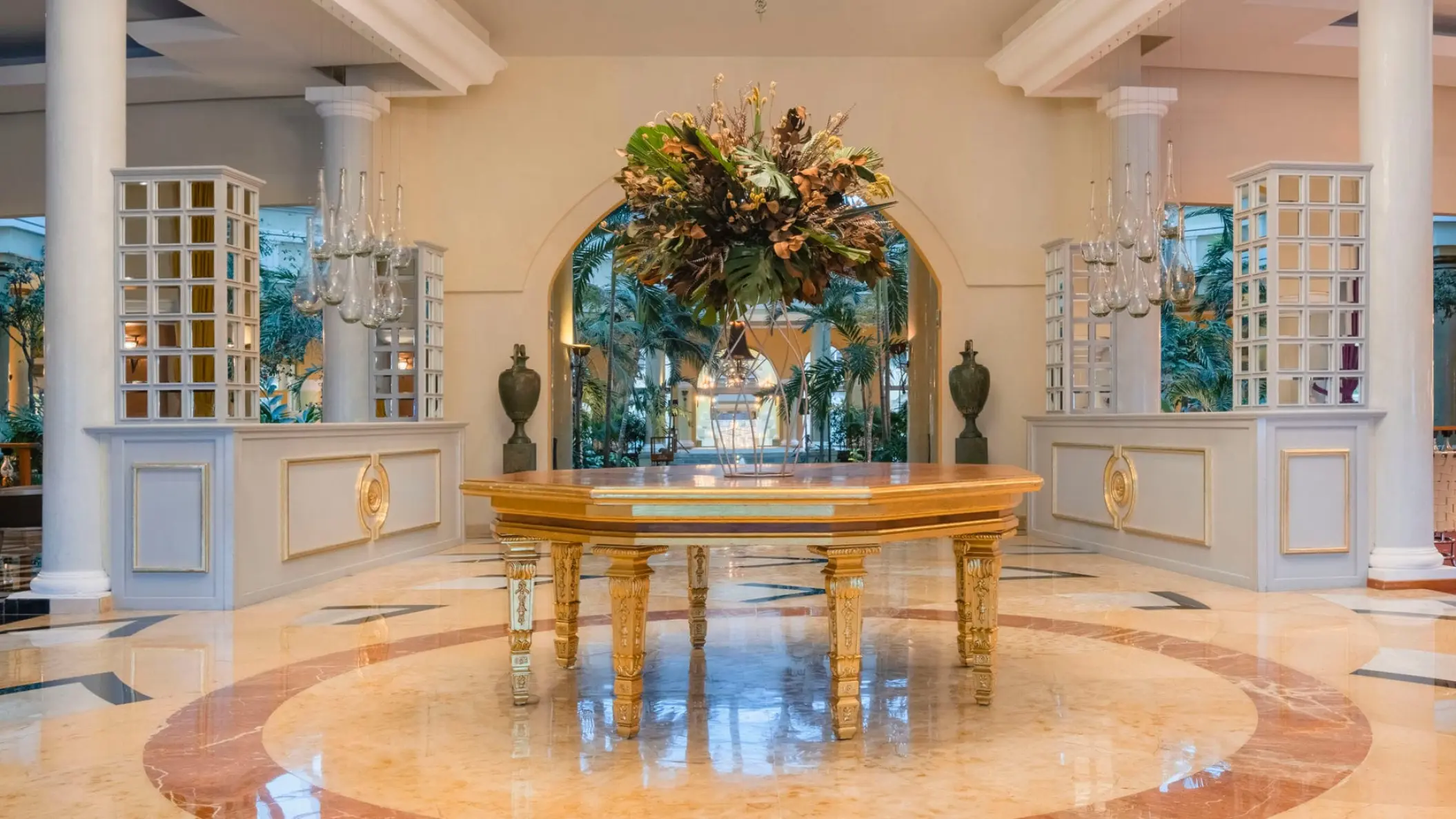 Elegant lobby with a large floral arrangement and gold table at JOIA Paraiso by Iberostar, Riviera Maya