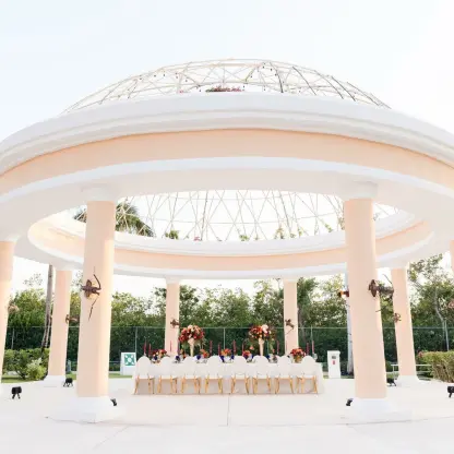 Stone gazebo wedding reception setup with long table at JOIA Paraiso by Iberostar, Riviera Maya