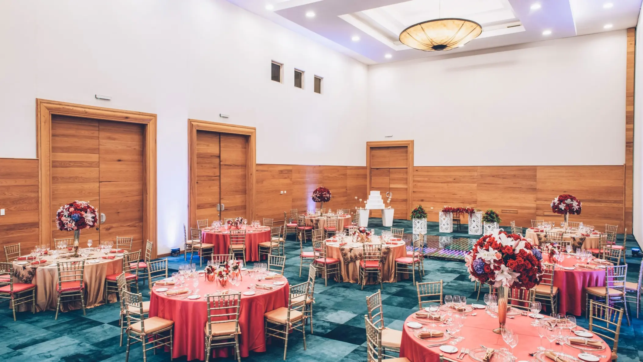 Wedding reception setup with round tables and pink linens in the ballroom at Iberostar Waves Paraiso Beach, Riviera Maya