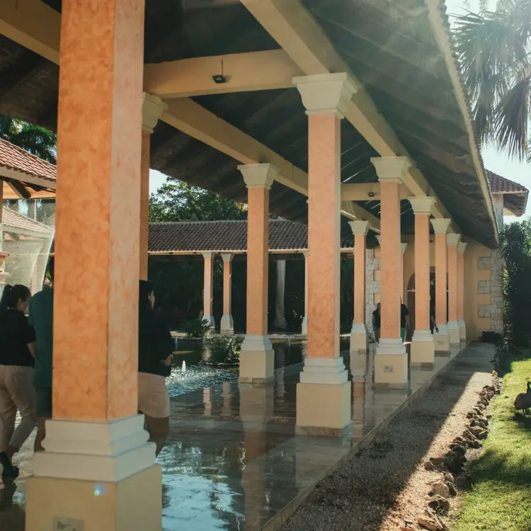 Covered walkway with pillars and water features at Iberostar Paraiso Beach, Riviera Maya