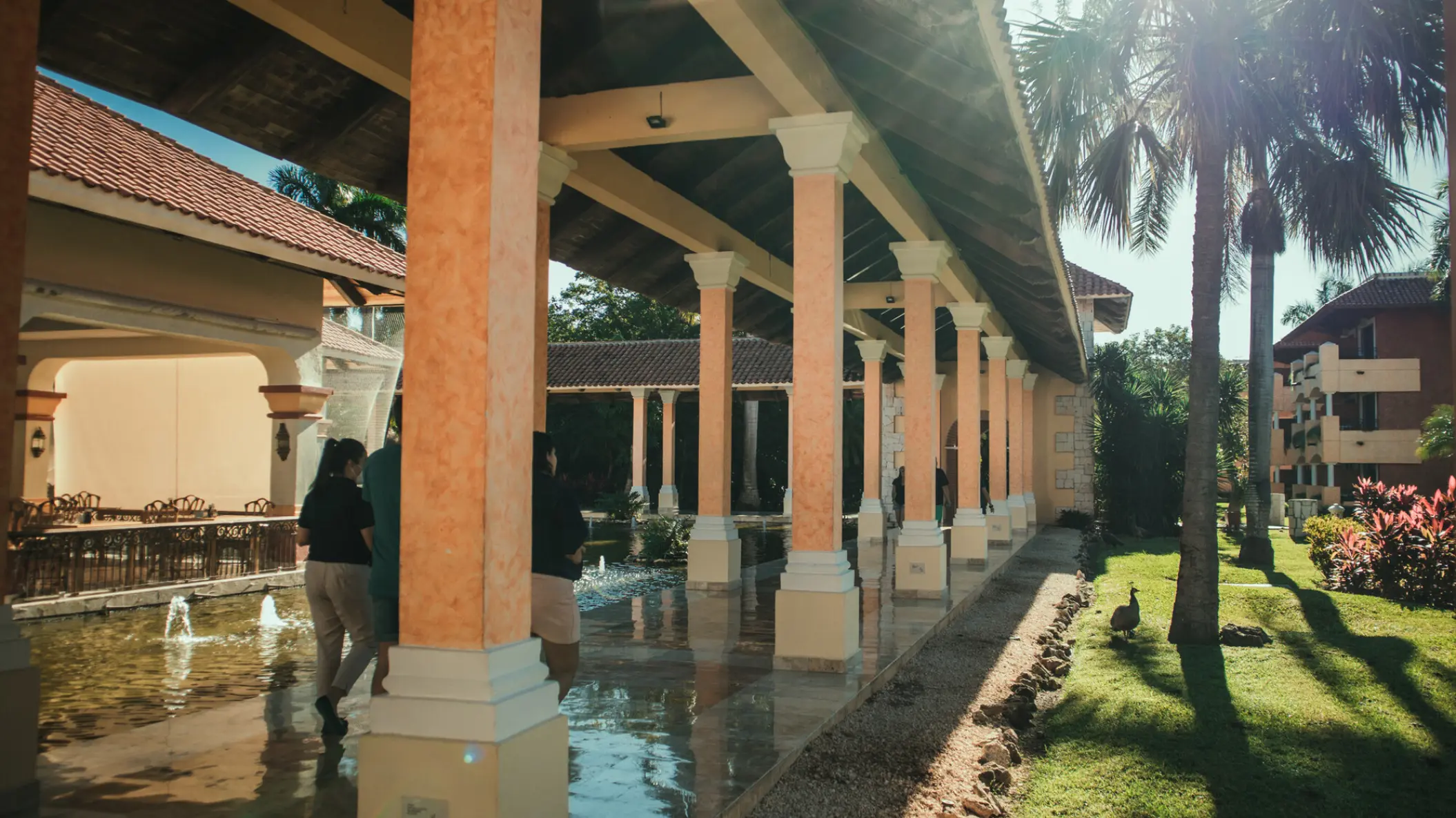 Covered walkway with pillars and water features at Iberostar Paraiso Beach, Riviera Maya
