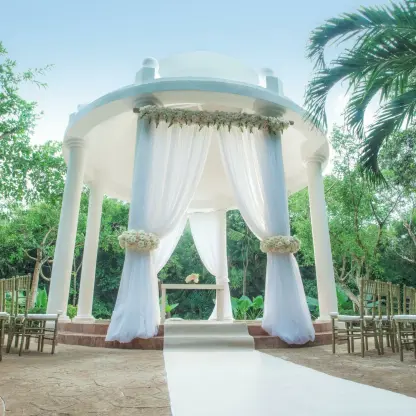 Stone gazebo wedding ceremony with white drapery at Iberostar Paraiso Del Mar, Riviera Maya