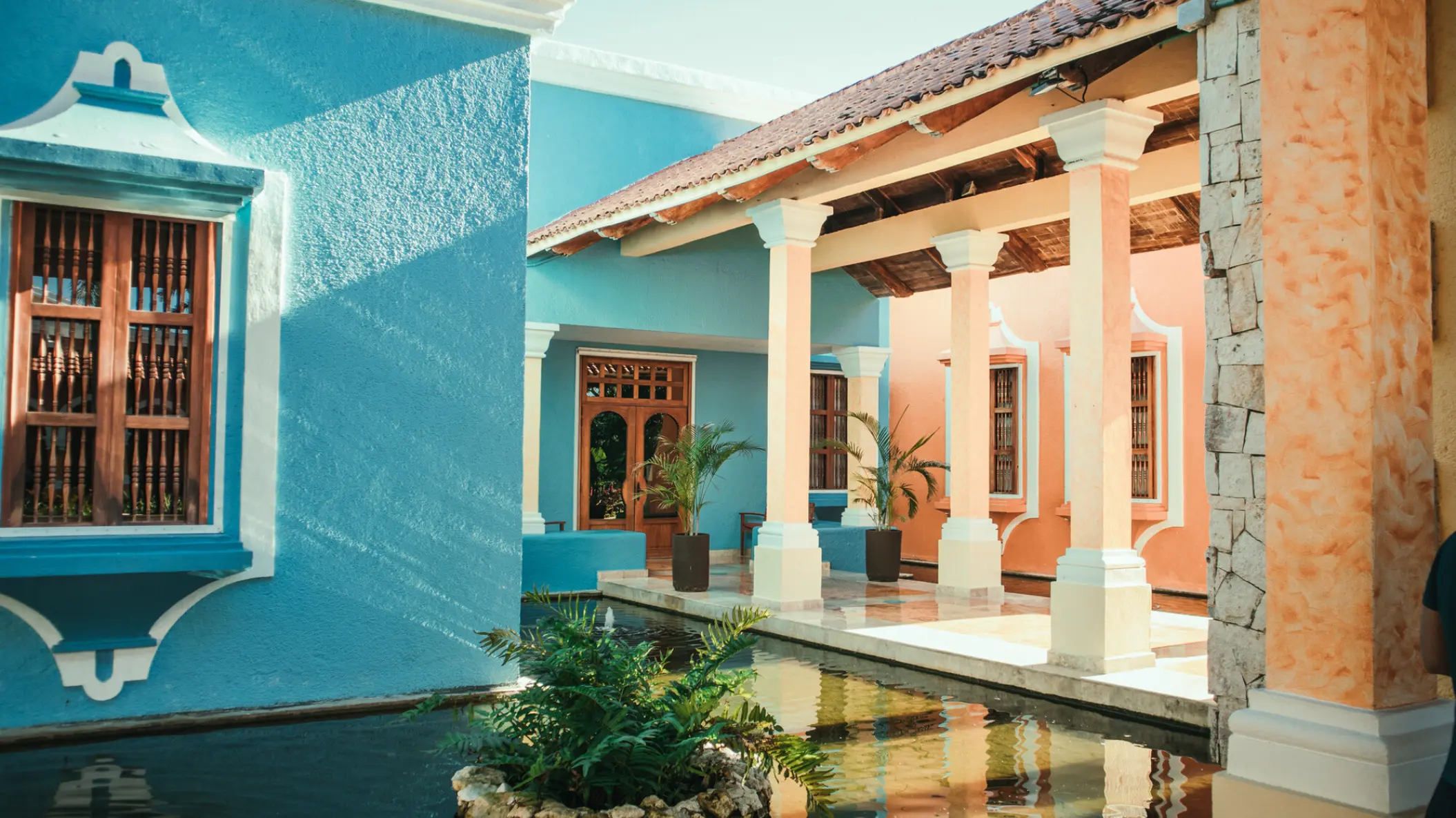 Colorful colonial-style courtyard and reflection pool at Iberostar Paraiso Beach, Riviera Maya