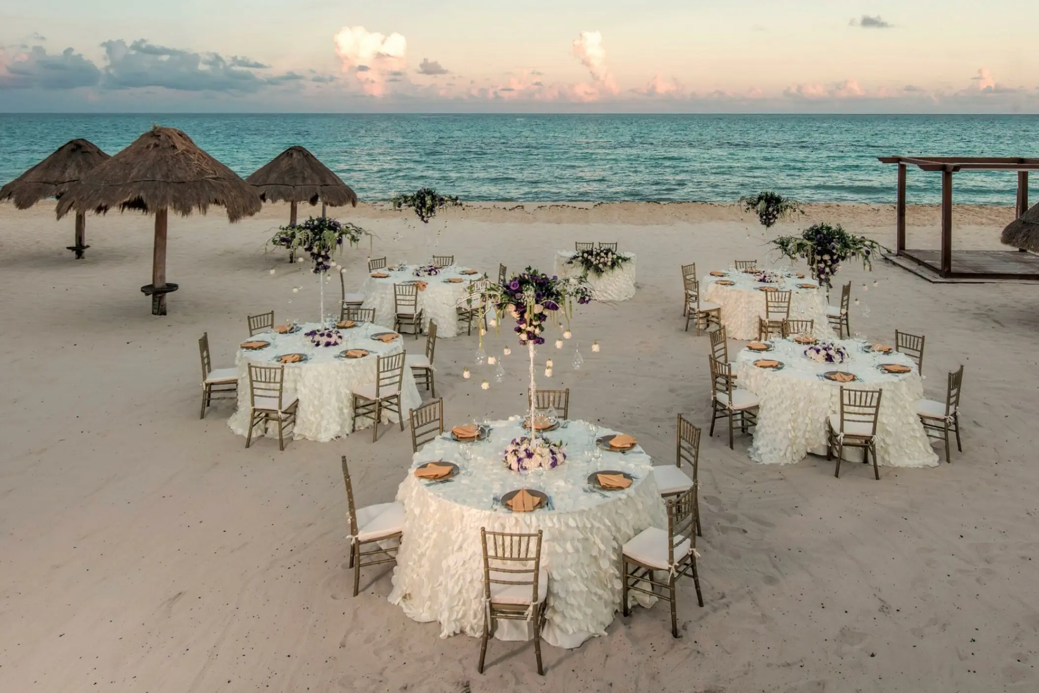 Beachfront wedding reception tables set on the sand at Iberostar Paraiso Beach, Riviera Maya