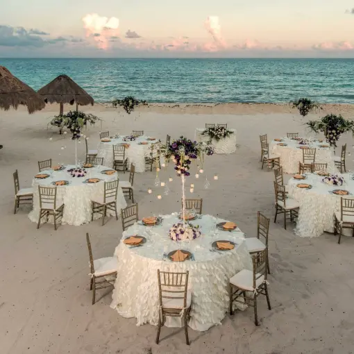 Beachfront wedding reception tables set on the sand at Iberostar Paraiso Beach, Riviera Maya