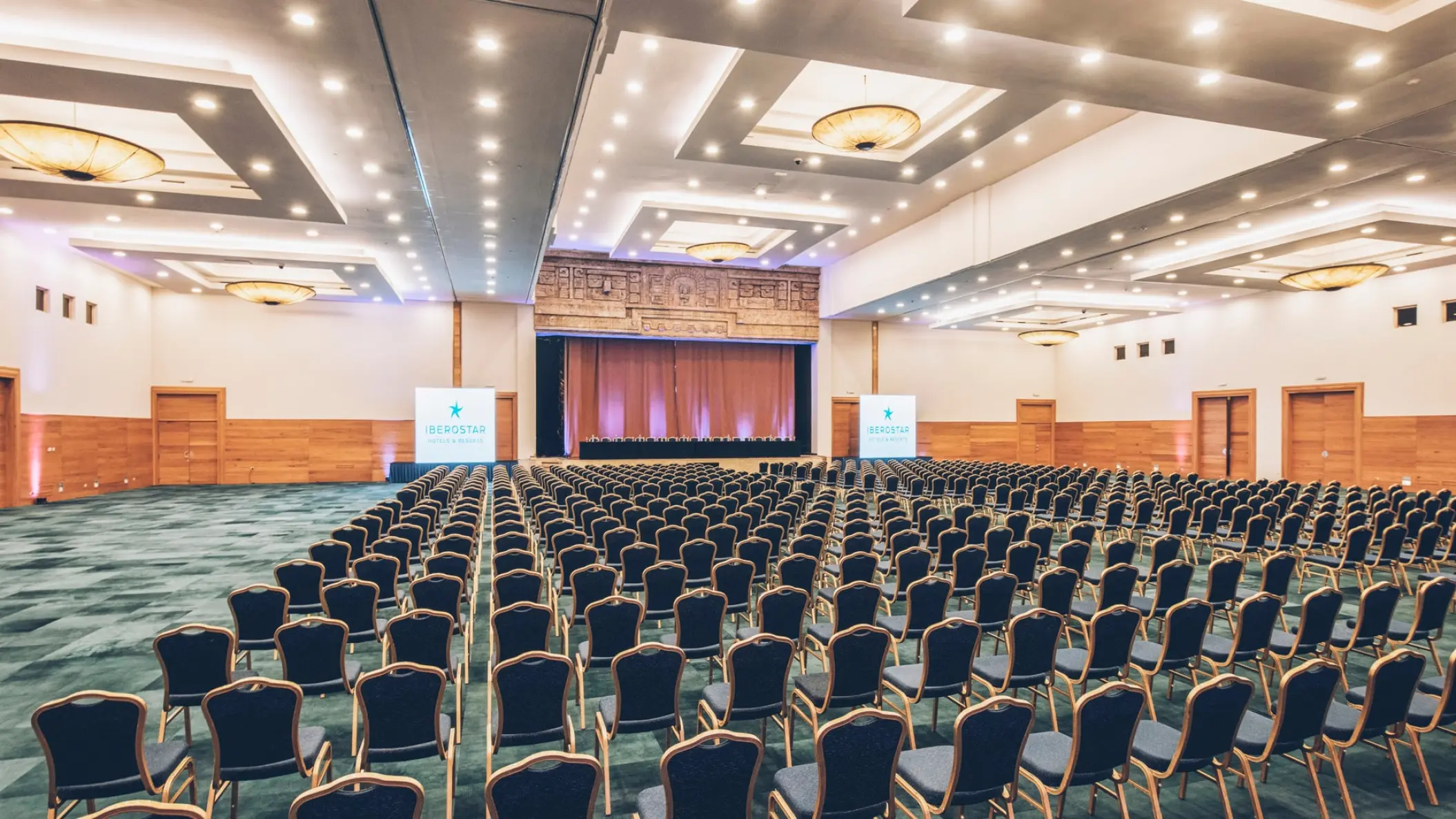 Indoor convention center with rows of theater-style seating at Iberostar Paraiso Del Mar, Riviera Maya