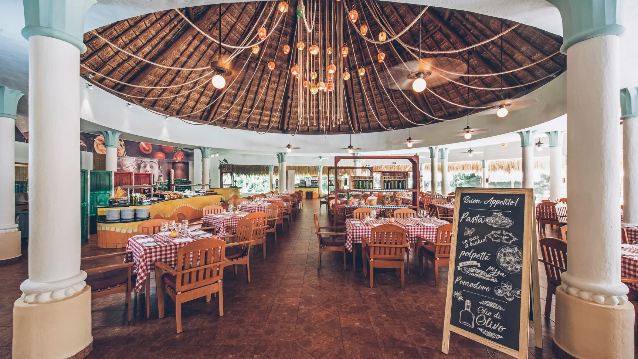 Open-air buffet restaurant with a palapa roof at Iberostar Paraiso Del Mar, Riviera Maya