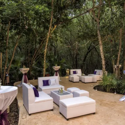 Jungle wedding reception lounge with white seating and purple accents at Iberostar Paraiso Del Mar, Riviera Maya
