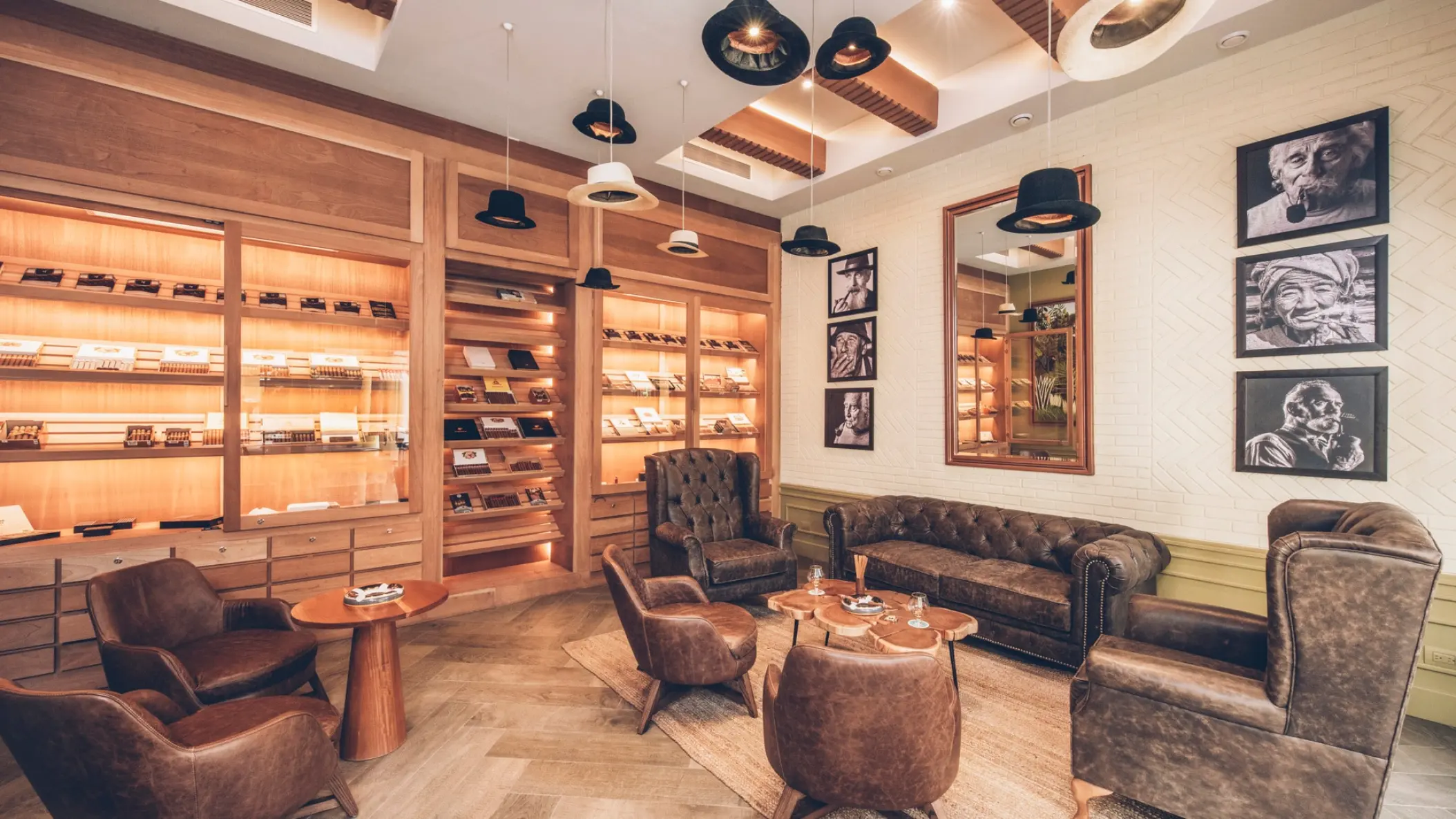 Cigar bar lounge with leather armchairs and hat-themed decor at Iberostar Selection Paraiso Lindo, Riviera Maya