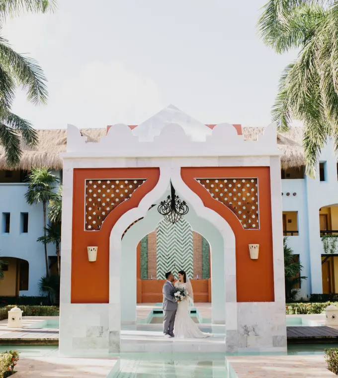 Bride and groom standing in the wedding gazebo at Iberostar Paraiso Lindo, Riviera Maya