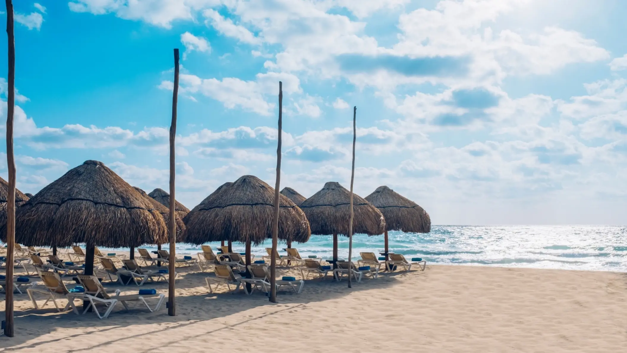 Straw umbrellas and lounge chairs on the beach at Iberostar Selection Paraiso Maya, Riviera Maya