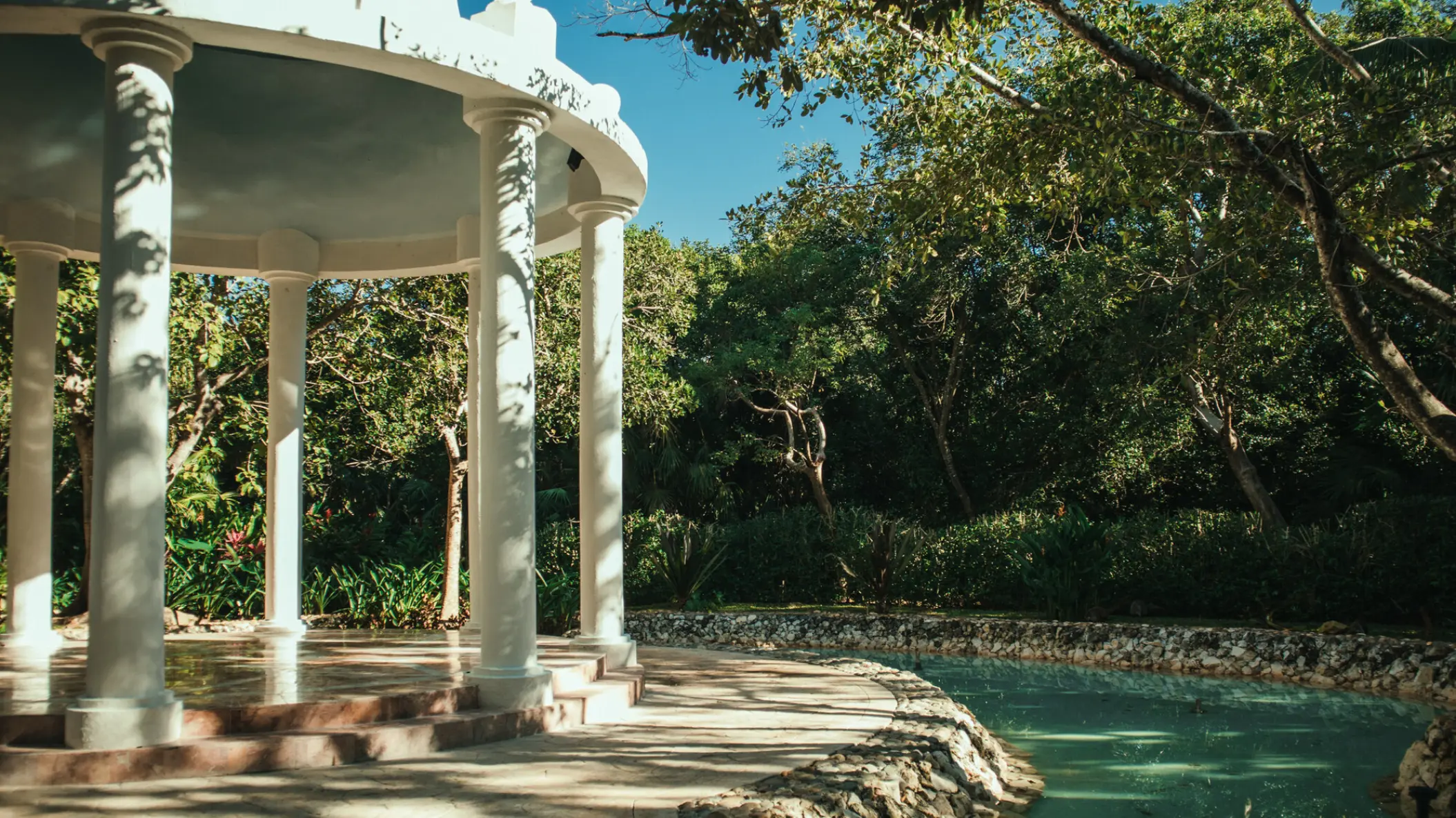 White garden gazebo wedding venue with stone columns at Iberostar Selection Paraiso Maya, Riviera Maya