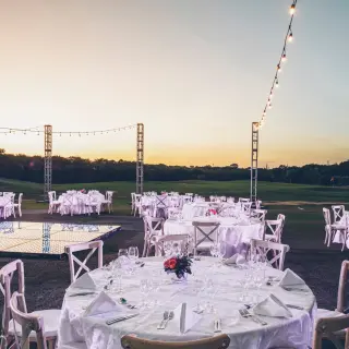 Garden wedding reception with white tables and string lights at Iberostar Paraiso Maya, Riviera Maya