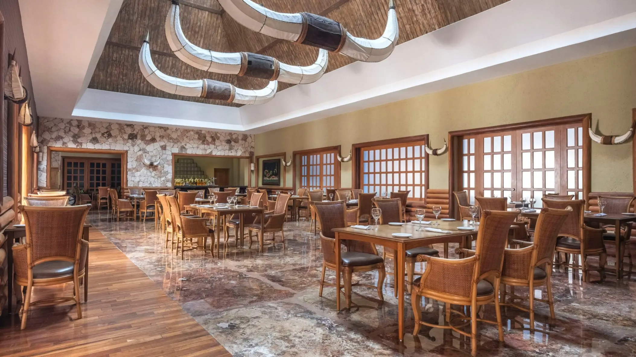 Steakhouse dining room with longhorn horn light fixtures at Iberostar Selection Paraiso Maya, Riviera Maya