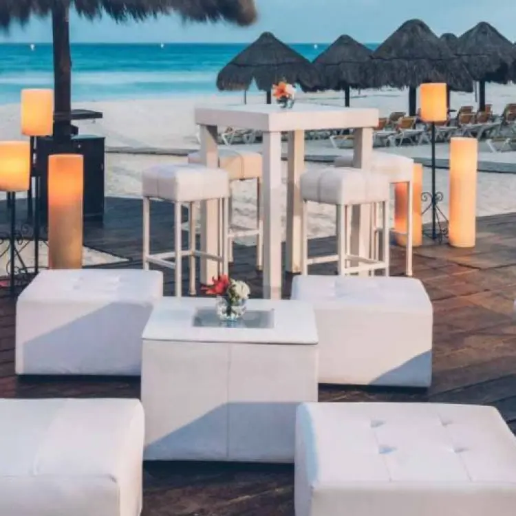 Beachfront wedding lounge setup with white furniture and lanterns at Iberostar Waves Quetzal, Playa Del Carmen