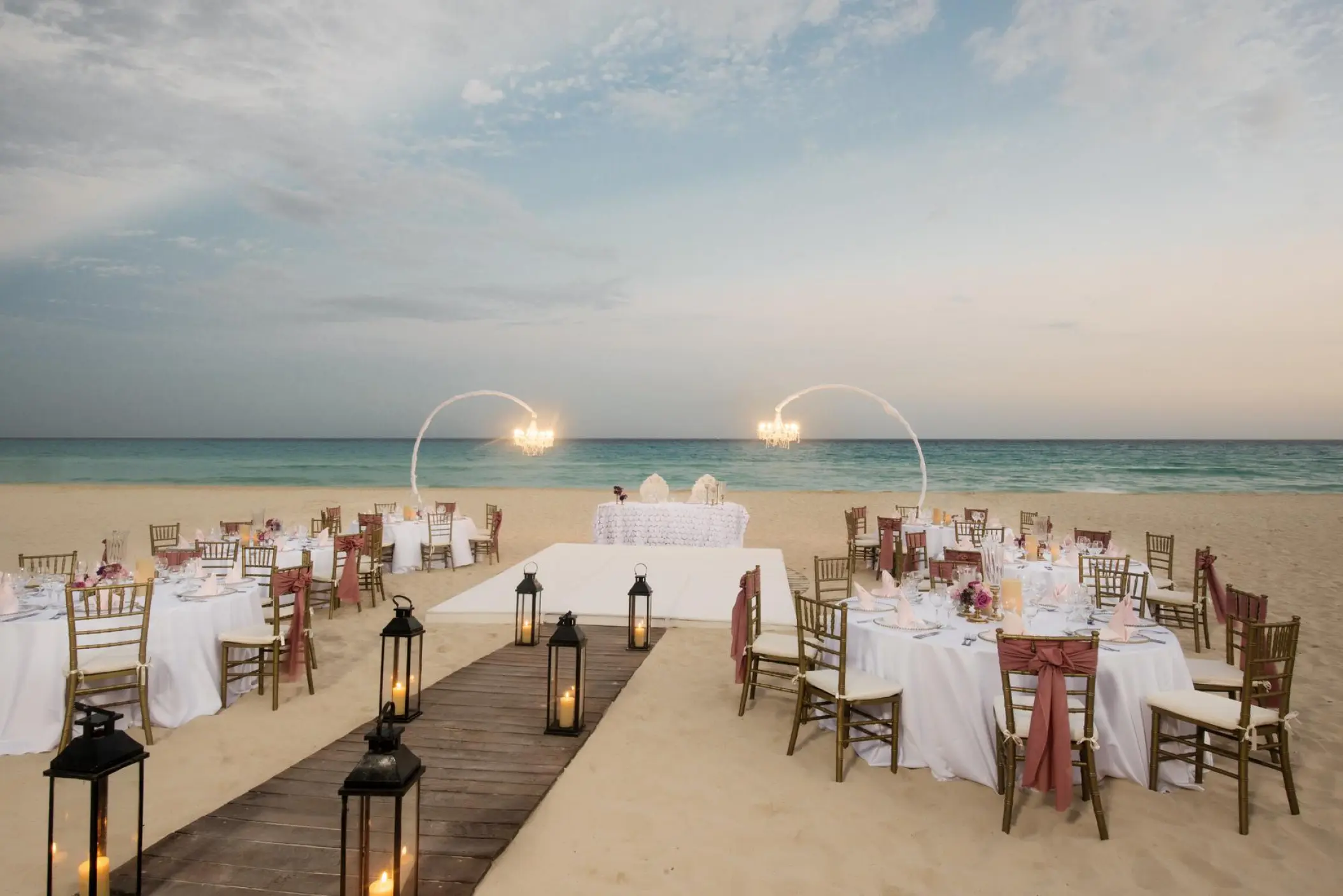 Beachfront wedding reception with lanterns and dance floor at Iberostar Waves Quetzal, Playa Del Carmen