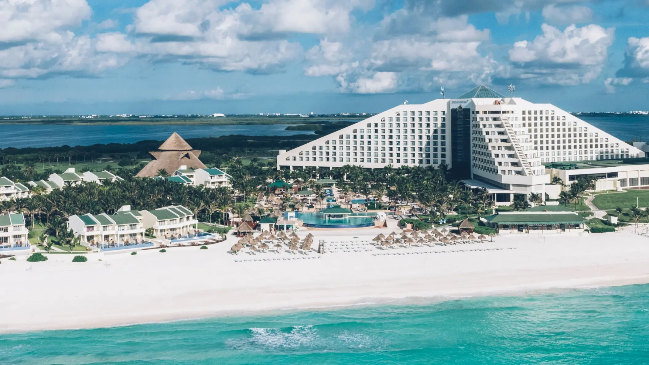 Iberostar Selection Cancun pyramid building and villas along the white sand beach, Cancun