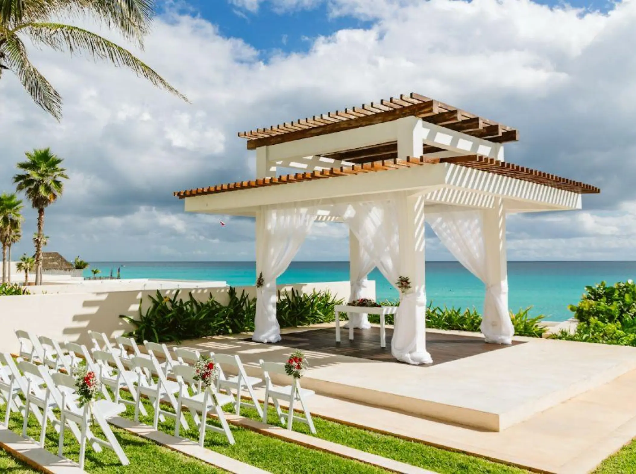 White gazebo wedding ceremony venue overlooking the ocean at Iberostar Selection Cancun