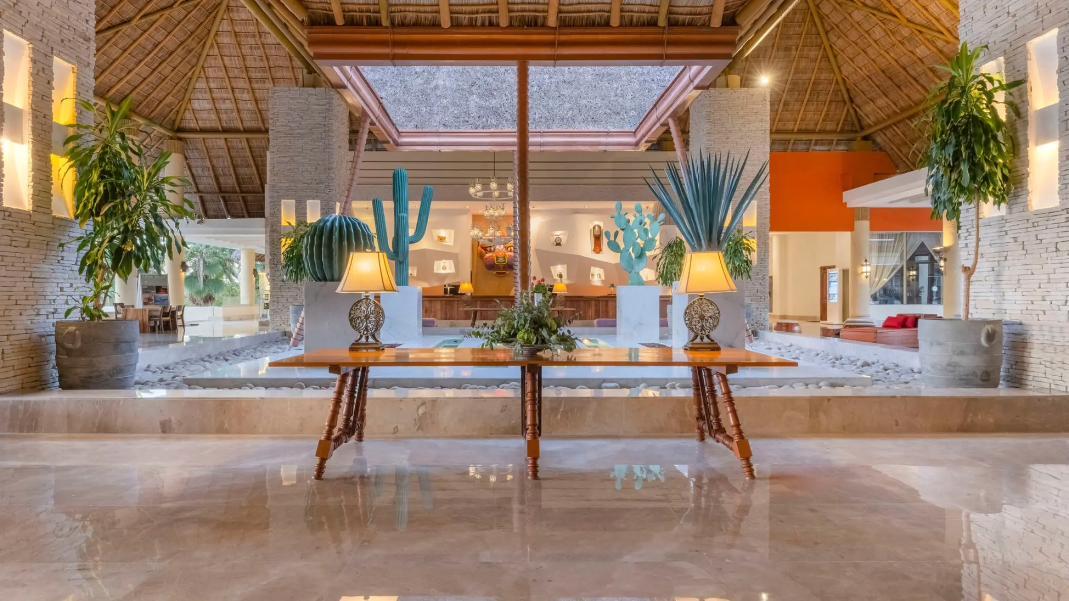 Open-air lobby with thatched roof and decorative cactus sculptures at Iberostar Selection Playa Mita, Puerto Vallarta