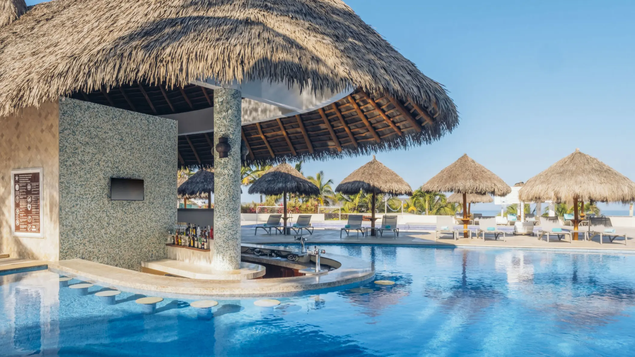 Swim-up bar with a palapa roof at Iberostar Selection Playa Mita, Puerto Vallarta