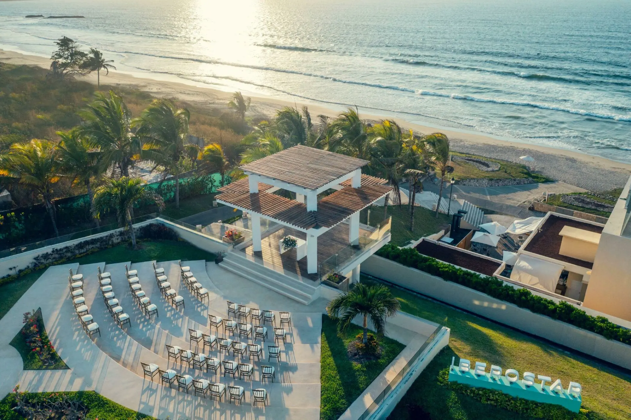 Aerial view of a beachfront wedding ceremony gazebo and seating at Iberostar Selection Playa Mita, Puerto Vallarta