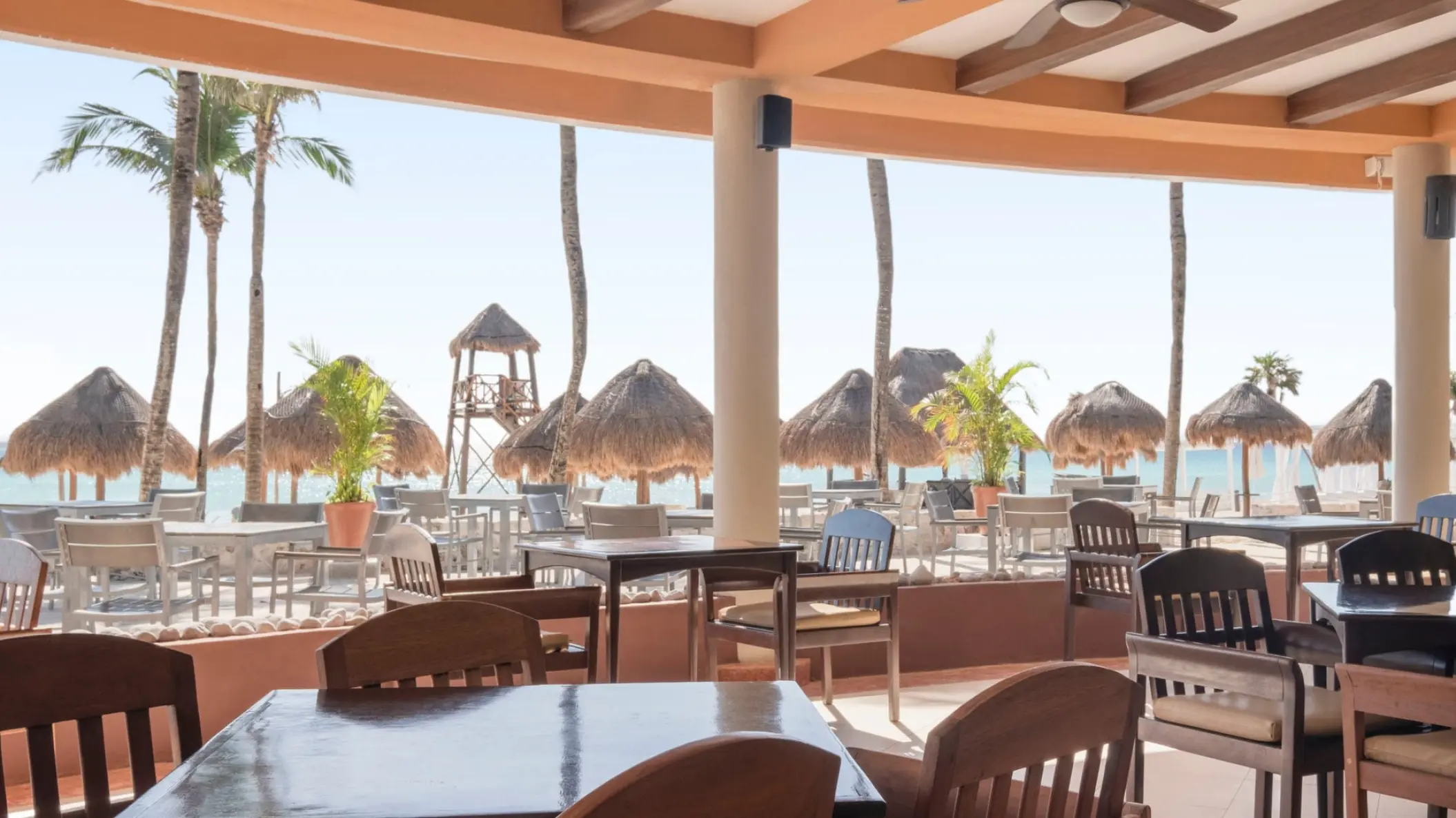 Iberostar Waves Tucan beach restaurant overlooking thatched umbrellas and the Caribbean Sea, Playa Del Carmen