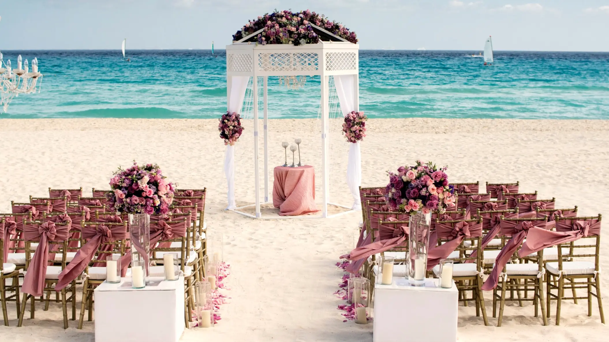 Beachfront wedding ceremony with a white gazebo and purple floral arrangements at Iberostar Waves Tucan, Playa Del Carmen