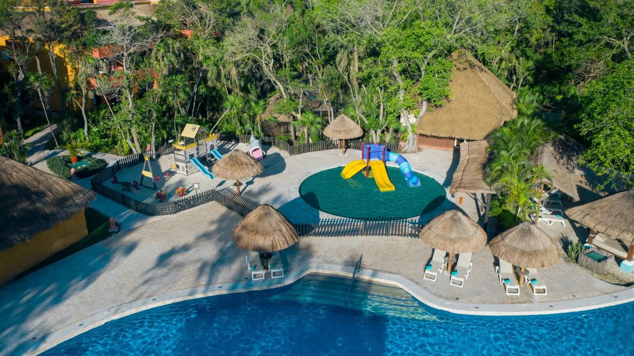 Kids waterpark with colorful slides and palapas at Iberostar Waves Tucan, Playa Del Carmen