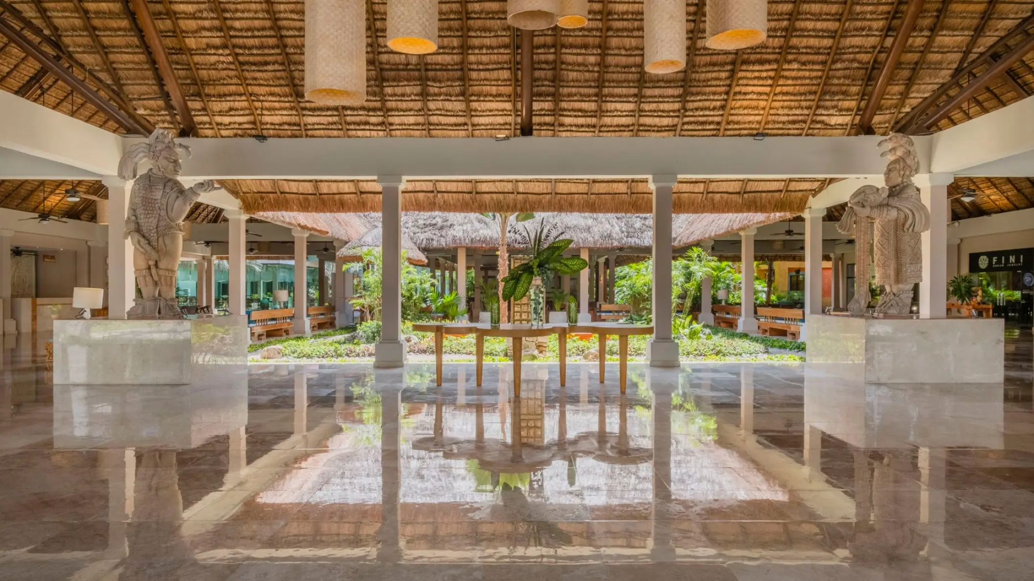 Open-air lobby with palapa roof and Mayan-style statues at Iberostar Waves Tucan, Playa Del Carmen