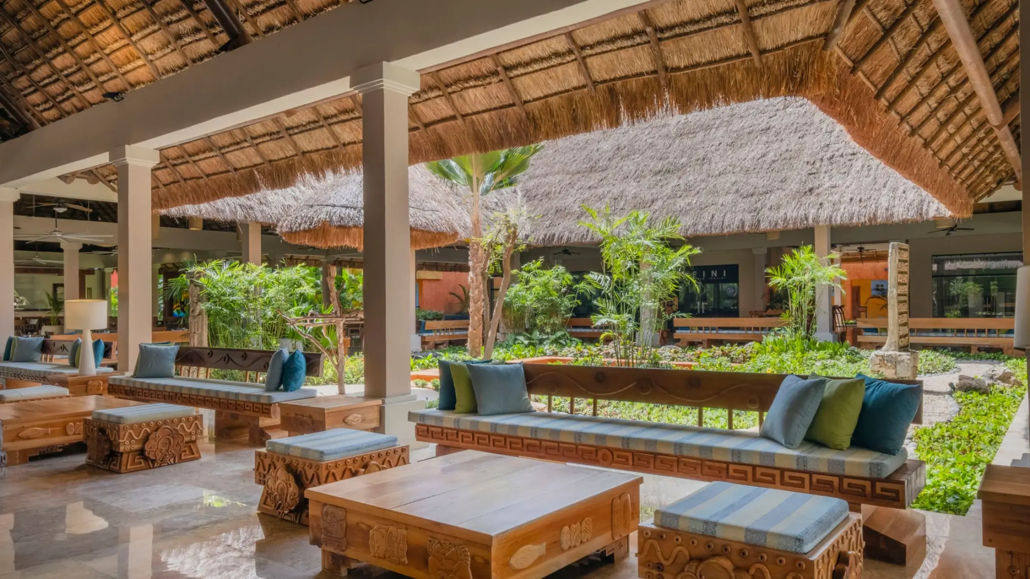 Open-air lobby lounge with thatched roofs and tropical garden views at Iberostar Waves Tucan, Playa Del Carmen