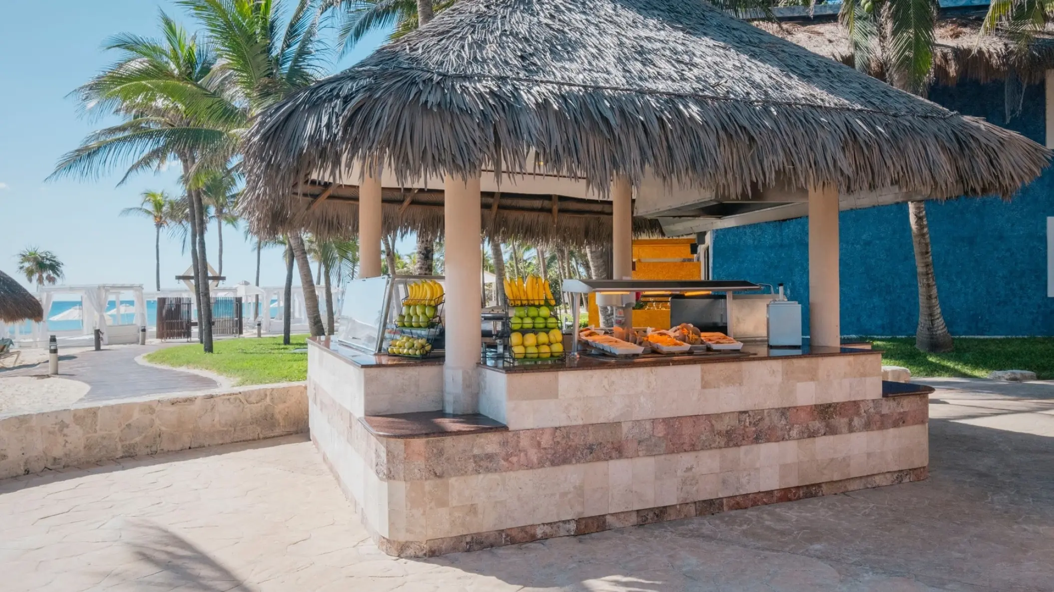 Outdoor thatched roof snack bar with fresh fruit at Iberostar Waves Tucan, Playa Del Carmen