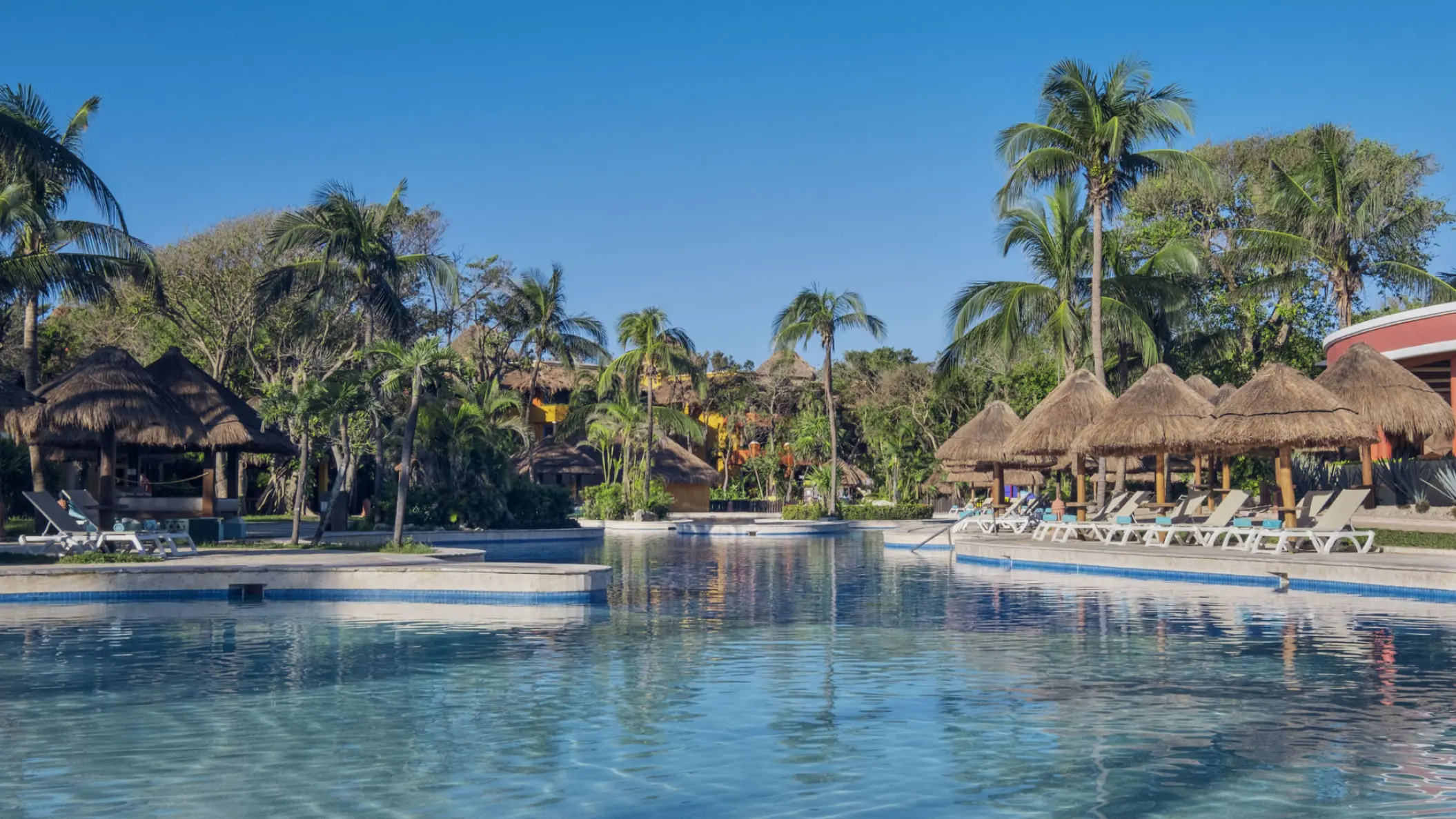 Iberostar Waves Quetzal swimming pool with palapa umbrellas and lounge chairs, Playa Del Carmen
