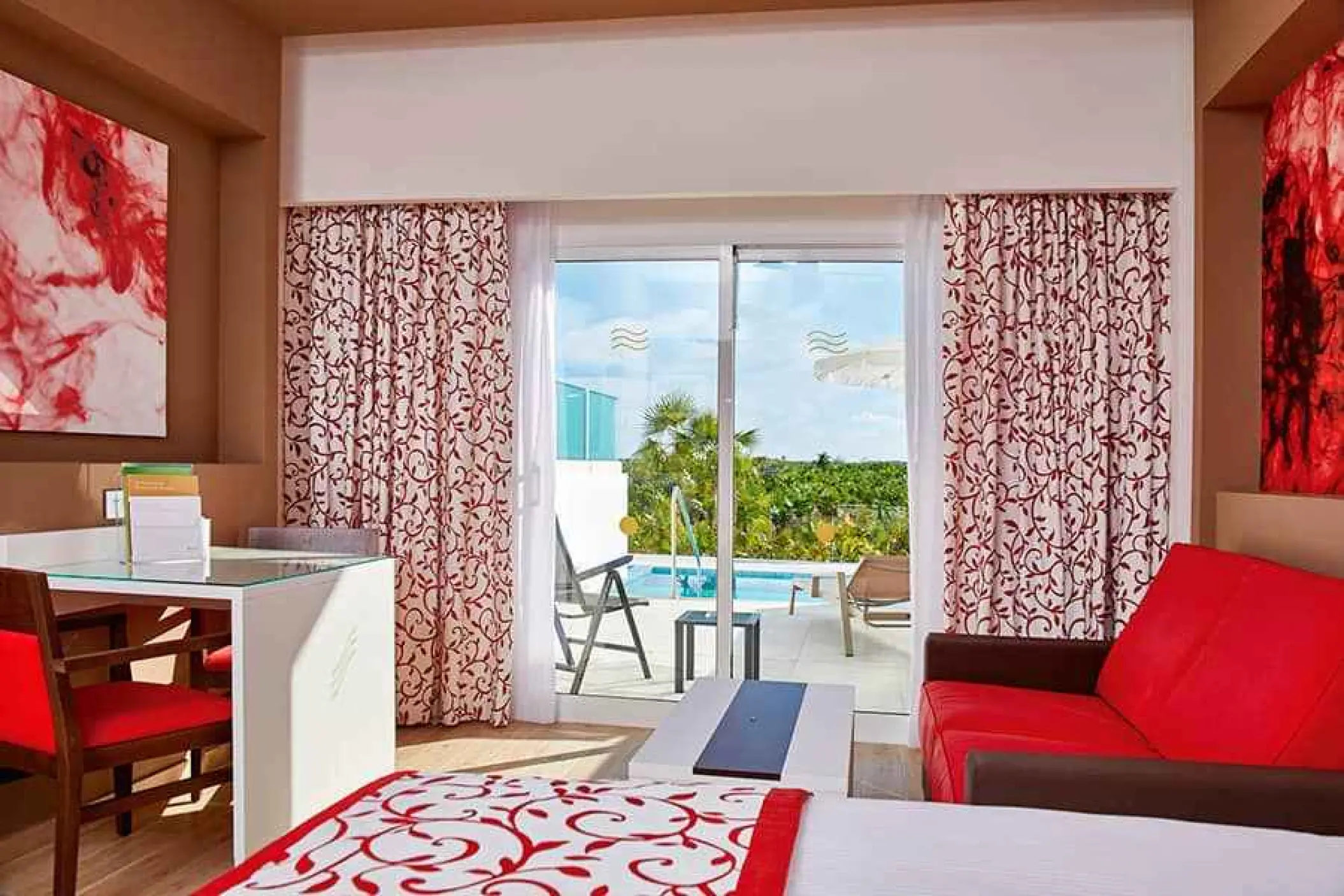Junior suite swim-out room with red accents at Riu Palace Costa Mujeres, Cancun