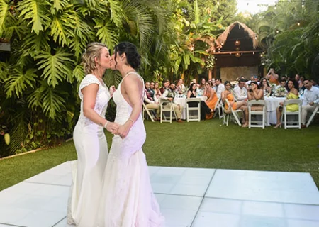 couple kisses during their fisrt dance while the group watch