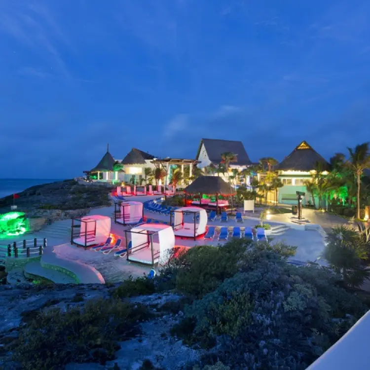 Kore Tulum pool deck and cabanas illuminated at dusk, Tulum