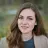 Paradise Weddings planner smiling outdoors against a blurred forest background