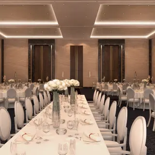 Blanc Sand Ballroom wedding reception setup with white floral centerpieces at Le Blanc Los Cabos