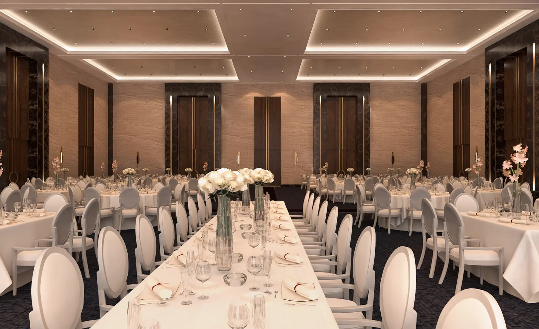 Blanc Sand Ballroom wedding reception setup with white floral centerpieces at Le Blanc Los Cabos